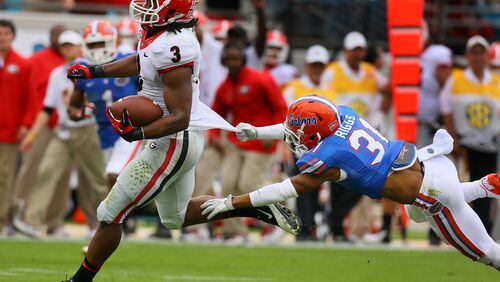 Georgia tailback Todd Gurley breaks away from Florida defensive back Cody Riggs who can't hold on to his jersey for a 70-yard plus touchdown run and a 14-0 lead during the first quarter on Saturday, Nov. 2, 2013, in Jacksonville.