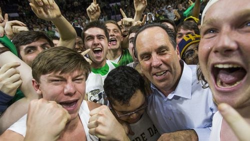 Notre Dame coach Mike Brey celebrates in the Notre Dame student section following his team’s game against Florida State on Saturday, Feb. 11, 2017, in South Bend, Ind. Notre Dame won 84-72. (AP Photo/Robert Franklin)