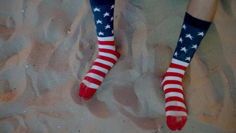 An American soccer fan wears his American flag socks as he waits for his team to play against Ghana at the FIFA World Cup Fan Fest on Copacabana beach on June 16, 2014 in Rio de Janeiro, Brazil.