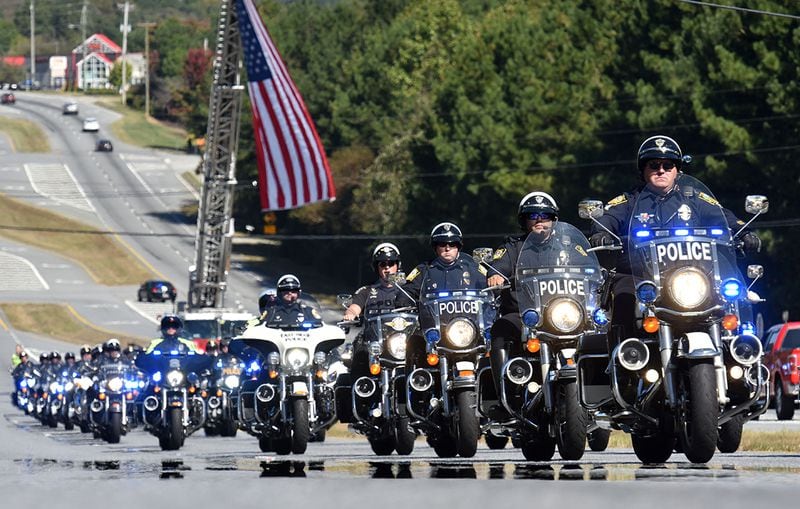 October 24, 2018 Lawrenceville - Police motorcycle procession escorts the hearse carrying Gwinnett County police officer Antwan Toney outside 12Stone Church on Buford Drive on Wednesday, October 24, 2018. Gwinnett County police officer Antwan Toney, 30, was shot and killed Saturday while responding to a call in the Snellville area. The California native worked for nearly three years for the Gwinnett police department. A funeral was hold at 11 a.m. Wednesday at 12Stone Church, 1322 Buford Drive in Lawrenceville. HYOSUB SHIN / HSHIN@AJC.COM