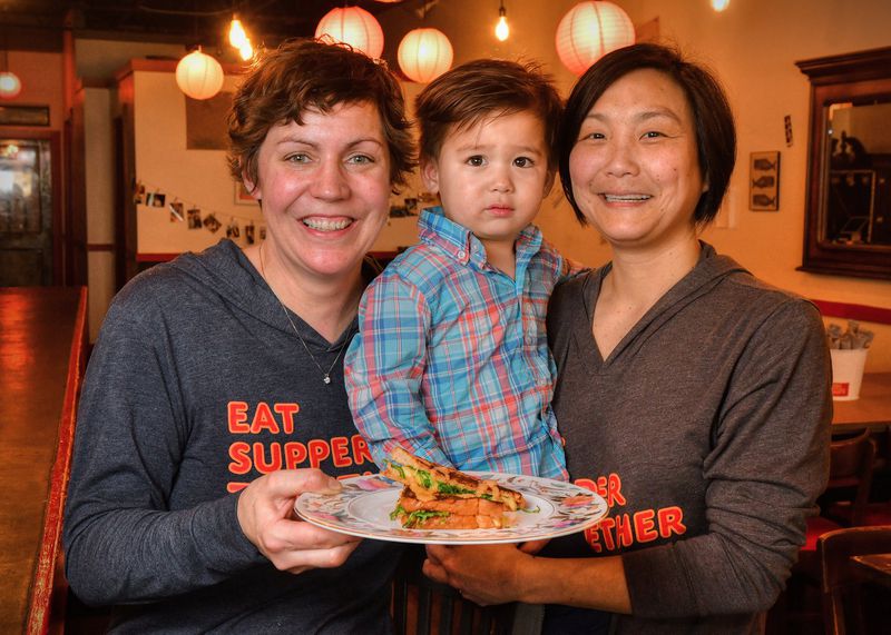 Emily Chan (left) of JenChan’s Delivery Supper Club in Cabbagetown won an award last year for The Sláinte grilled cheese sandwich. She is shown with her son Mik Chan (2 years old) and wife Jen Chan. STYLING BY EMILY CHAN / CONTRIBUTED BY CHRIS HUNT PHOTOGRAPHY