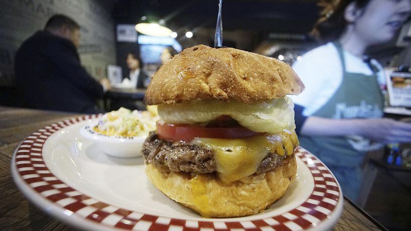 A 100 percent U.S. Angus beef Colby Jack Cheeseburger as part of U.S. President Donald Trump set is seen at Munch's Burger Shack restaurant in Tokyo Thursday, Nov. 16, 2017. The cheeseburger Trump had during his recent visit to Japan is still drawing lines at the Tokyo burger joint. (AP Photo/Eugene Hoshiko)