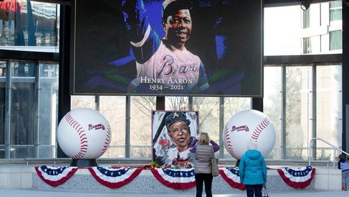 Karen Kasprowicz (left) and her mother, June Chandler, take a photograph of the Hank Aaron memorial at Truist Park on Saturday, January 23, 2021, a day after the baseball legend died. (Photo: Steve Schaefer for The Atlanta Journal-Constitution)