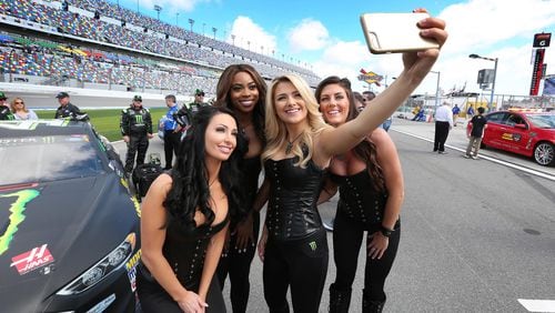 The Monster Energy girls pose for a selfie on Pit Road before the Clash at Daytona NASCAR race on Sunday, Feb. 19, 2017, at Daytona International Speedway in Daytona Beach, Fla.