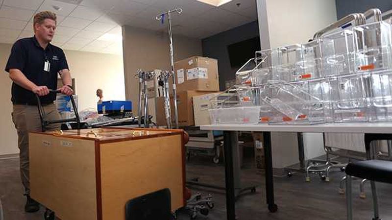 A University of North Georgia facilities department employee moves medical equipment into the new nursing skills and simulation labs. The new labs are part of the renovated and repurposed spaces on UNG's Gainesville Campus that formerly housed Lanier Technical College. More departments will relocate into the buildings throughout the summer. PHOTO CREDIT: UNIVERSITY OF NORTH GEORGIA.