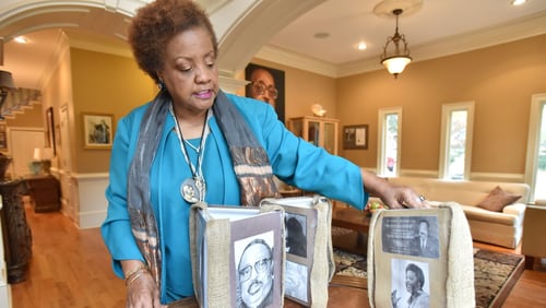 Elisabeth Williams-Omilami, daughter of Hosea Williams, shows photographs of her late father at her home on Nov. 30, 2016. HYOSUB SHIN / HSHIN@AJC.COM