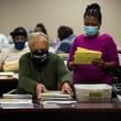 Workers sort absentee ballots at the DeKalb County Elections Office on Wednesday, January 6, 2021. (Rebecca Wright for The Atlanta Journal-Constitution)