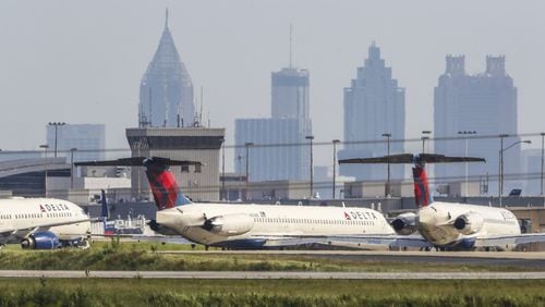 Dozens of commercial jets remained parked along a runway and taxiways at Hartsfield-Jackson on Wednesday, April 29, 2020. JOHN SPINK/JSPINK@AJC.COM