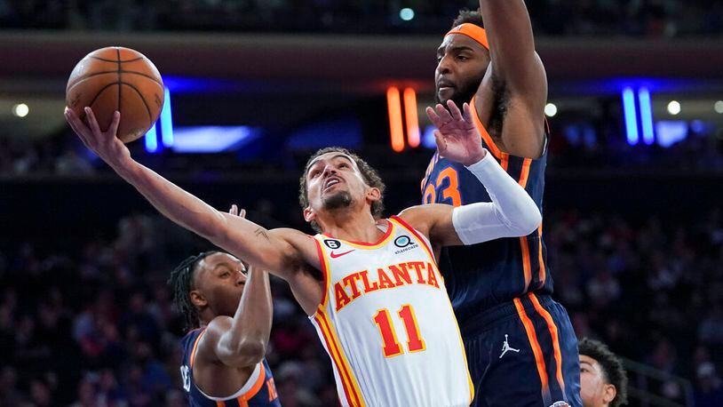 Atlanta Hawks guard Trae Young (11) goes to the basket against New York Knicks center Mitchell Robinson (23) during the first half of an NBA basketball game Wednesday, Dec. 7, 2022, at Madison Square Garden in New York. (AP Photo/Mary Altaffer)