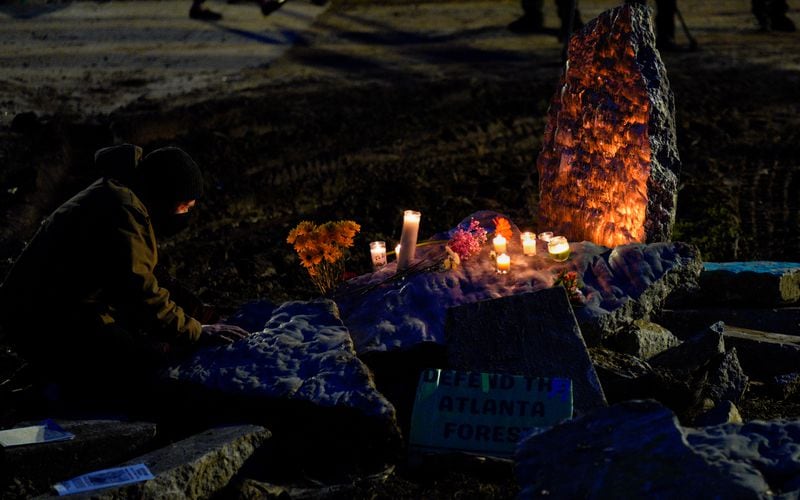 A memorial surrounded by candles and flowers pays respect to activist Manuel Teran, who died Wednesday in an incident involving law enforcement officers. Dozens gathered at Weelaunee People’s Park in Atlanta to remember the activist Friday evening, January 20, 2023. (Ben Hendren for The Atlanta Journal-Constitution)