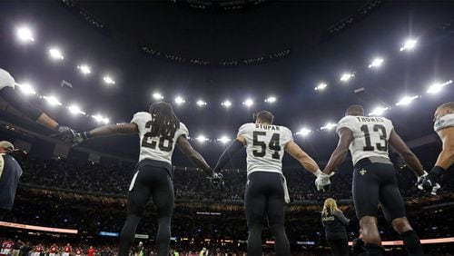 New Orleans Saints and Atlanta Falcons players form a unity demonstration on the field before an NFL football game in New Orleans, Monday, Sept. 26, 2016.