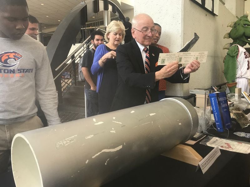 Clayton State University President Thomas "Tim" Hynes shows some items put in a time capsule left on the campus in 1994. The time capsule was opened on Sept. 19, 2019 as part of the college's 25th anniversary. ERIC STIRGUS / ESTIRGUS@AJC.COM