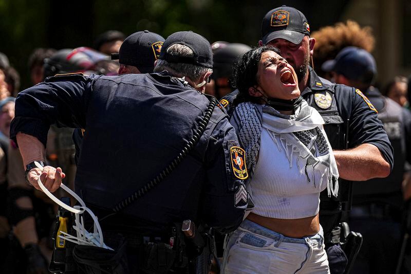 A pro-Palestinian protester yells "Free Palestine" as she is handcuffed by University of Texas at Austin police on the campus Monday, April 29, 2024, in Austin, Texas. (Aaron E. Martinez/Austin American-Statesman via AP)