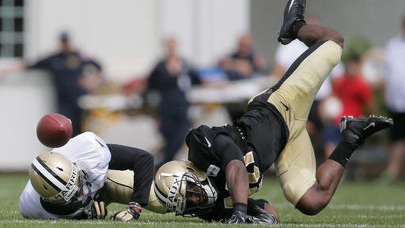 FILE - In this July 30, 2016, file photo, New Orleans Saints cornerback Delvin Breaux, right, breaks up a pass intended for wide receiver Reggie Bell during the NFL football team's training camp, in White Sulphur Springs, W. Va. After a recent decision to part ways with veteran Keenan Lewis, New Orleans' revamped defense is relying increasingly on first and second-year cornerbacks to slow down opposing receivers. (David Grunfeld/NOLA.com - The Times-Picayune via AP, File)