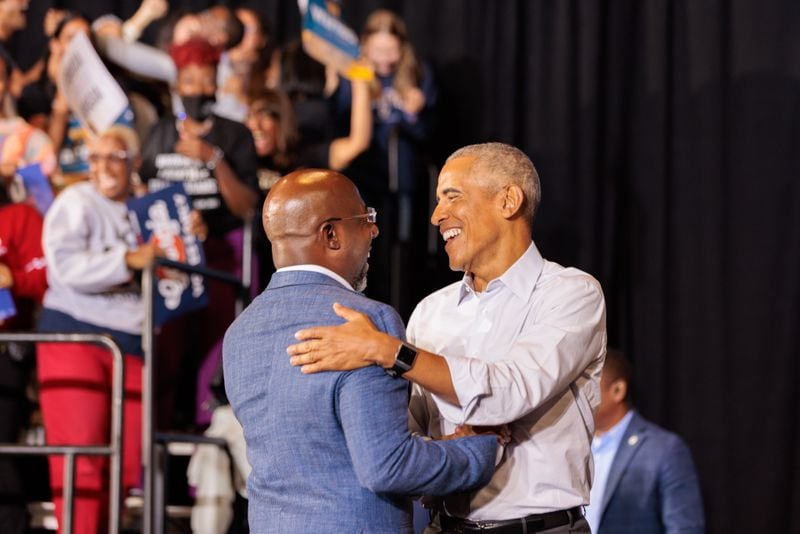 Former President Barack Obama embraces U.S. Sen. Raphael Warnock at a campaign event for Democrats in Atlanta on Oct. 28, 2022.  (Arvin Temkar/AJC)