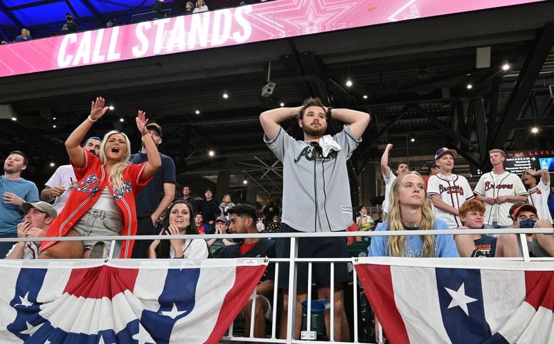 Braves fans react after a call by Atlanta disputing a ninth-inning run scored by the Philadelphia Phillies is upheld Sunday, April 11, 2021, at Truist Park in Atlanta. The Phillies won 7-6. (Hyosub Shin / Hyosub.Shin@ajc.com)
