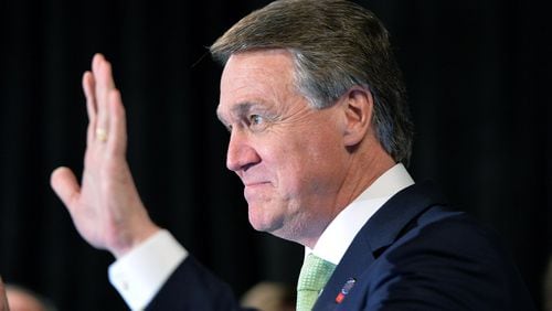 David Perdue waves to his supporters at his election night party at Doubletree Hotel in Buckhead on May 20, 2014. Perdue served on the Georgia Ports Authority while a business he owned with his cousin, former Gov. Sonny Perdue, trucked goods to and from the port. HYOSUB SHIN / HSHIN@AJC.COM