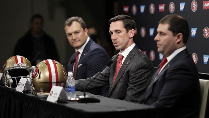 San Francisco 49ers head coach Kyle Shanahan, center, answers questions next to general manager John Lynch, left, and owner Jed York during an NFL football press conference Thursday. (AP Photo/Marcio Jose Sanchez)