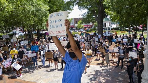 Walton High School student Joseph Fisher, 18, demonstrates on the square during a protest over the recent Minneapolis police killing of George Floyd, held Wednesday, June 3, 2020, in Marietta, Ga. JOHN AMIS FOR THE ATLANTA JOURNAL-CONSTITUTION