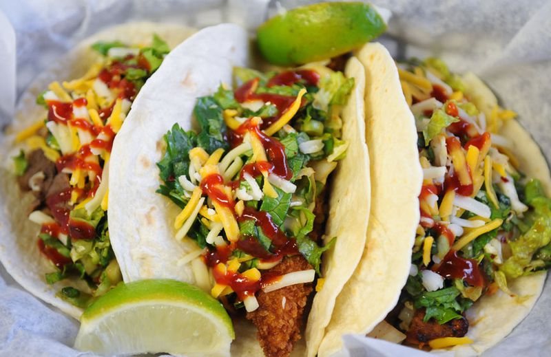 Marinated rib-eye stars in the beef taco, panko-crusted tilapia nestles in the fish taco and the chicken taco has had a bath in spicy Korean sauce.