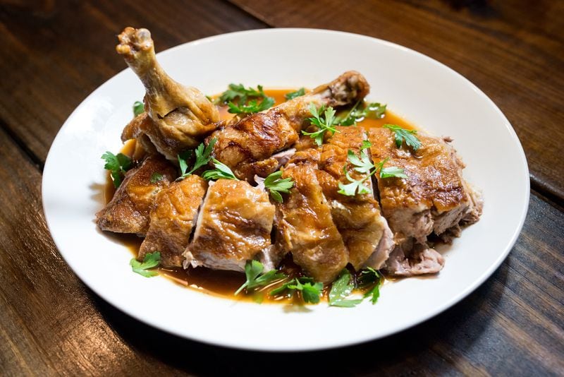 Slow roasted half duck with sauce. Photo credit: Mia Yakel Photography
