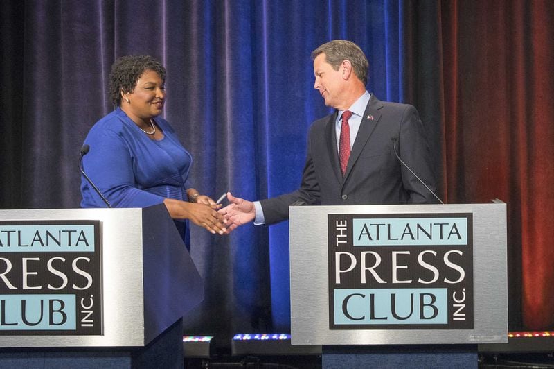 Georgia gubernatorial Democratic candidate Stacey Abrams and Republican candidate Brian Kemp greet each other before a live taping of the 2018 gubernatorial debate for the Atlanta Press Club at the Georgia Public Broadcasting studio in Atlanta on Oct. 23, 2018. 