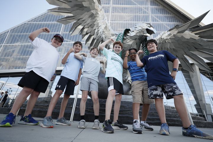 Kids from Brooke Stone School in Columbus, Ga, react in front of the Falcon at the Mercedes-Benz Stadium before the game against the Columbus Crew on Saturday, May 28, 2022. Miguel Martinez / miguel.martinezjimenez@ajc.com
