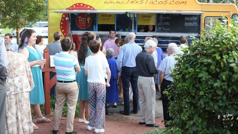 Customers line up to get some Tex's Taco food truck offerings.
