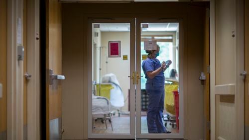 A staff member at Emanuel Medical Center in Swainsboro works in a special unit in 2020. A new multi-year CDC study has found that people in rural Georgia and nationwide are more likely to die early than those in urban areas. (Stephen B. Morton/AJC 2020 file photo)