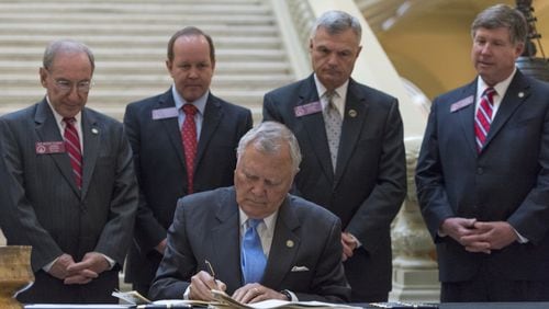Gov. Nathan Deal signs the First Priority Act, aimed at aiding low-performing schools, in Atlanta on April 27, 2017. (DAVID BARNES / DAVID.BARNES@AJC.COM)
