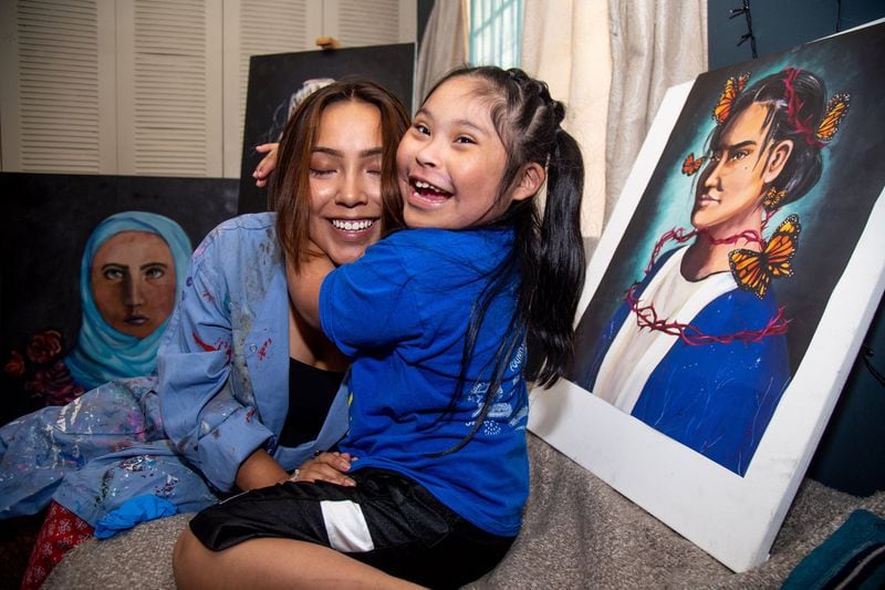 María B. (L) talks with her sister Ariana at her Smyrna home on July 2, 2019. STEVE SCHAEFER / SPECIAL TO THE AJC