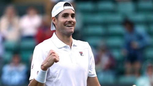 John Isner celebrates defeating Milos Raonic of Canada during their Men's Singles quarterfinals match on day nine of the Wimbledon Lawn Tennis Championships at All England Lawn Tennis and Croquet Club on July 11, 2018 in London.