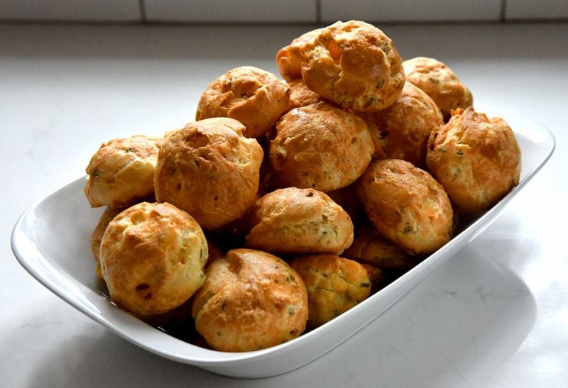 Gruyere, black pepper and mustard powder help make these Gougeres delightful. (Styling by Ashley Thomas and Morgan Perkins / Chris Hunt for the AJC)