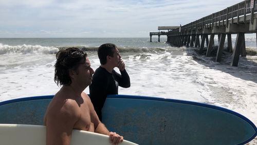 “All of the Georgia surfers come down for the hurricane swells,” said Brian Cail,  (no shirt) who was surfing with his buddy Tyler Bragg. Both are from Tybee. “It’s been okay. But we actually thought it would be a little bigger.”