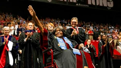 This photo provided by UA Strategic Communications Autherine Lucy Foster acknowledges the crowd as she receives a an honorary doctoral degree during a commencement exercise at The University of Alabama on Friday, May 3, 2019 in Tuscaloosa, Ala. The university bestowed the honorary doctorate degree to Foster, the first African American to attend the university.