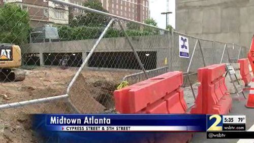 Crews are working to repair a sinkhole on 5th Street in Midtown. (Credit: Channel 2 Action News)
