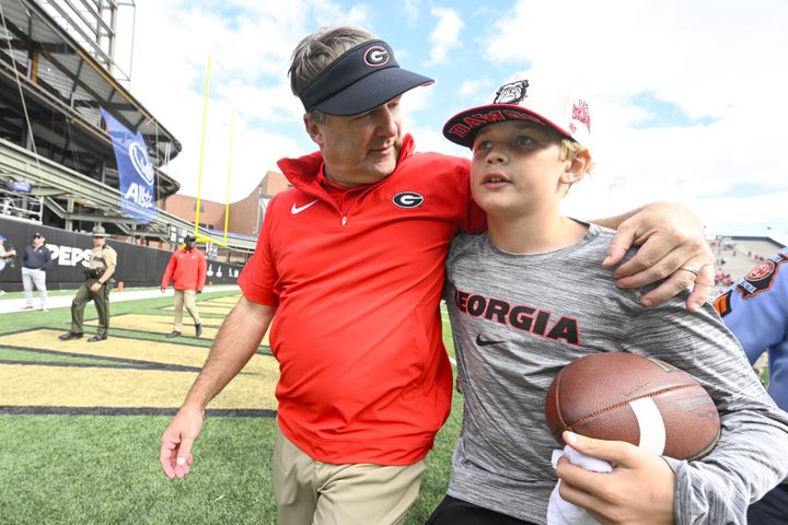 Georgia head coach Kirby Smart walks off the field with son Andrew after an NCAA football game against Vanderbilt, Saturday, Oct. 14, 2023, in Nashville, Tenn. Georgia won 37-20. (Special to the AJC/John Amis)