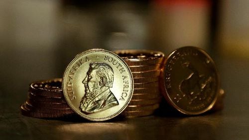 An employee of ProAurum gold house presents the 1 Ounce South African Krugerrand Fine Gold Coin in the safe deposit boxes room in Munich, Germany, Thursday, Dec. 13, 2018.