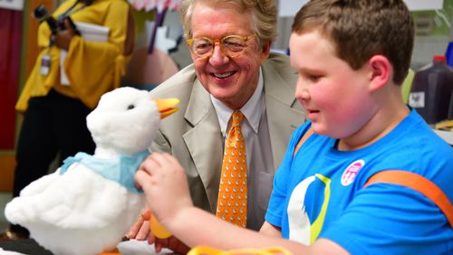 Aflac Chairman and CEO Dan Amos delivers a My Special Aflac Duck to Ethan Daniels of Alpharetta at the first “Duck Delivery” event, which was held at the Aflac Cancer and Blood Disorders Center at Children’s Healthcare of Atlanta during Childhood Cancer Awareness Month in 2018.