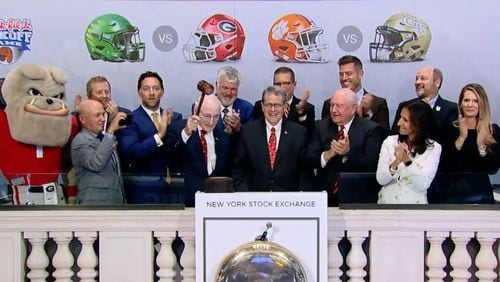 Former Georgia athletic director Vince Dooley bangs a gavel during the NYSE market close ceremony on Thursday. Screen capture from NYSE Closing Bell video)
