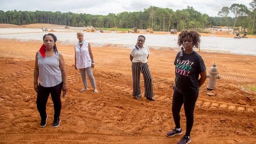 Stonecrest residents (from left to right) Renee Cail, Jake Bryant, Jennifer Wilson and Pyper Bunch at the construction site of the planned Metro Green concrete recycling plant, located across the street from a subdivision. STEVE SCHAEFER FOR THE ATLANTA JOURNAL-CONSTITUTION