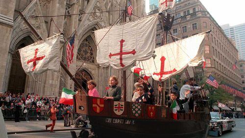 A model of the 'Santa Maria,' one of Christopher Columbus' three ships, is pulled up New York's Fifth Ave. with children aboard Monday, Oct. 14, 1996, in front of St. Patrick's Cathedral during the 56th Columbus Day Parade. (AP Photo/Marty Lederhandler)