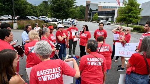 Jennifer Susko (center) leads Cobb County community members as they rally to demand the removal of Superintendent Chris Ragsdale outside the district offices on Thursday, Sept. 14, 2023, in Marietta.  (Hyosub Shin / Hyosub.Shin@ajc.com)