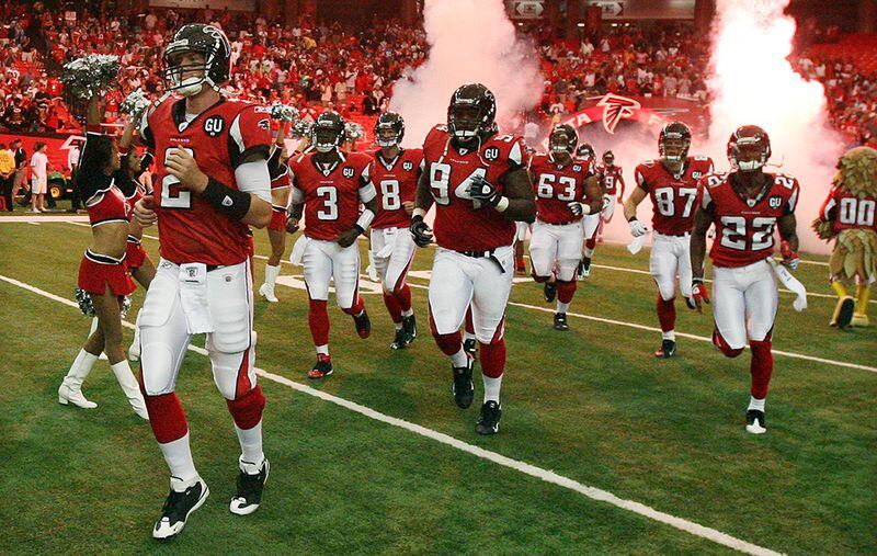 Matt Ryan leads the offense onto the field for his NFL debut Sunday, Sept. 7, 2008, at the Georgia Dome against the Detroit Lions. ( Curtis Compton/ AJC)