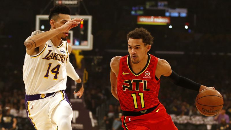 Hawks guard Trae Young moves the ball down the court as the Lakers' Danny Green trails during the first half Nov. 17, 2019, at Staples Center in Los Angeles.