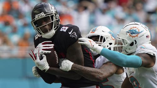 Falcons tight end Kyle Pitts (8) makes a catch, defended by Miami Dolphins cornerback Xavien Howard (25) and Miami Dolphins free safety Jevon Holland (8) late  in the second half Sunday, Oct. 24, 2021, in Miami Gardens, Fla. (Hans Deryk/AP)