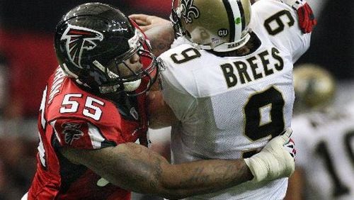 John Abraham hits Saints quarterback Drew Brees in the first half. Brees came into the game as the NFL's top-rated passer, but he threw three interceptions against the Falcons.