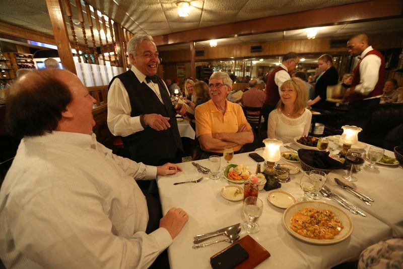 Alfredo “Perry” Alvarez Jr., owner of Alfredo's, talks with diners April 25, 2016, the last night the Cheshire Bridge Road fixture was open. The Italian restaurant opened in 1974. Ben Gray / bgray@ajc.com