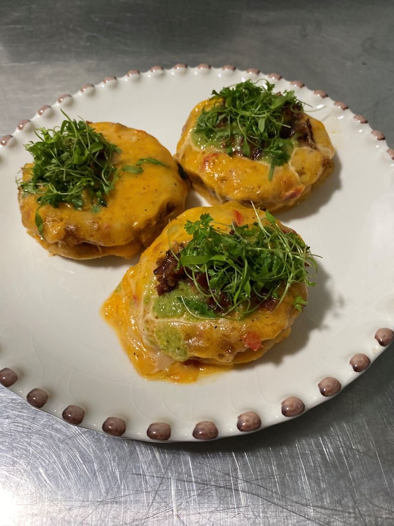 Joy Cafe’s fried green-tomato tarts are made by stacking a puff pastry disc moistened with bacon jam with a fried green tomato, pimento cheese and crumbled bacon. Wendell Brock for The Atlanta Journal-Constitution