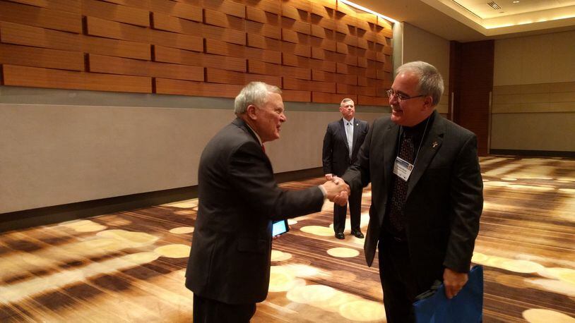 Gov. Nathan Deal shakes hands with Georgia School Superintendent Richard Woods before Deal’s 2016 speech to school leaders about his proposed Opportunity School District. TY TAGAMI/AJC
